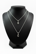 E and C Silver Initial Necklaces Together on Black Holder