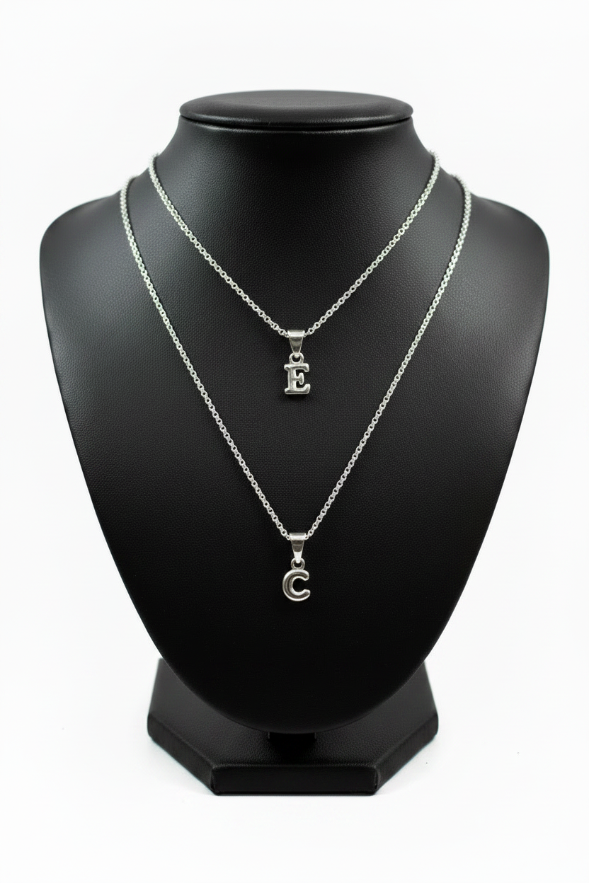 E and C Silver Initial Necklaces Together on Black Holder