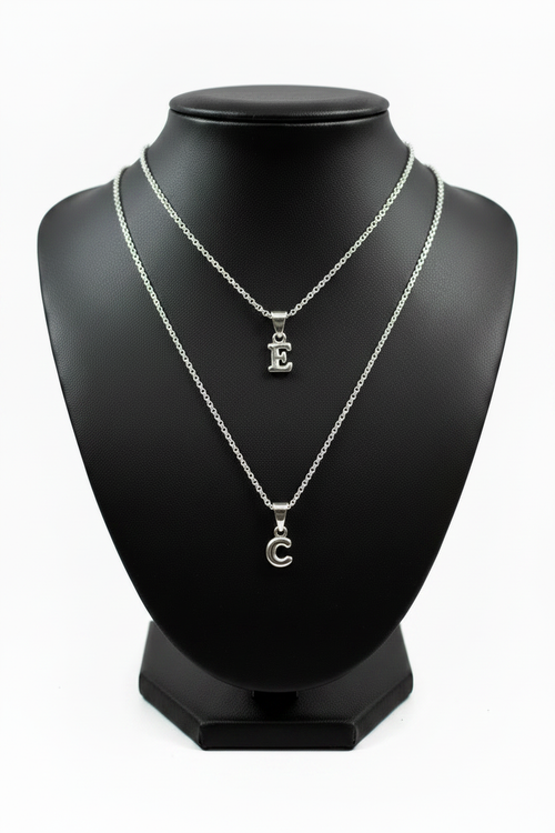 E and C Silver Initial Necklaces Together on Black Holder