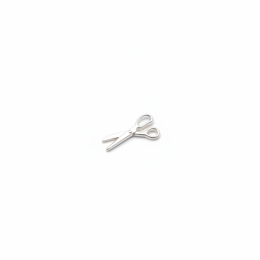 Silver scissors charm on white background